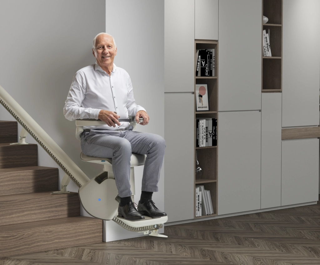 aelterer-mann-sitzt-im-installierten-treppenlift2 Ein älterer Mann sitzt im installierten Treppenlift und fährt nach oben | TK Home Solutions
